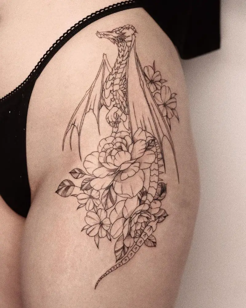 Tattoo of a dragon standing on flowers