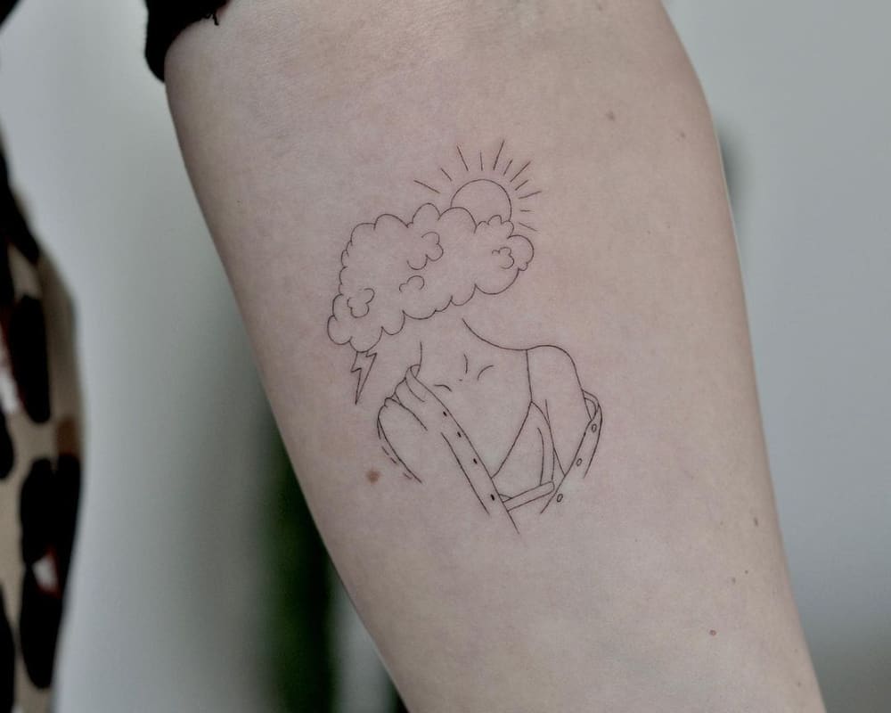 Tattoo of a female silhouette with a cloud instead of a head from which the sun and lightning are looking out