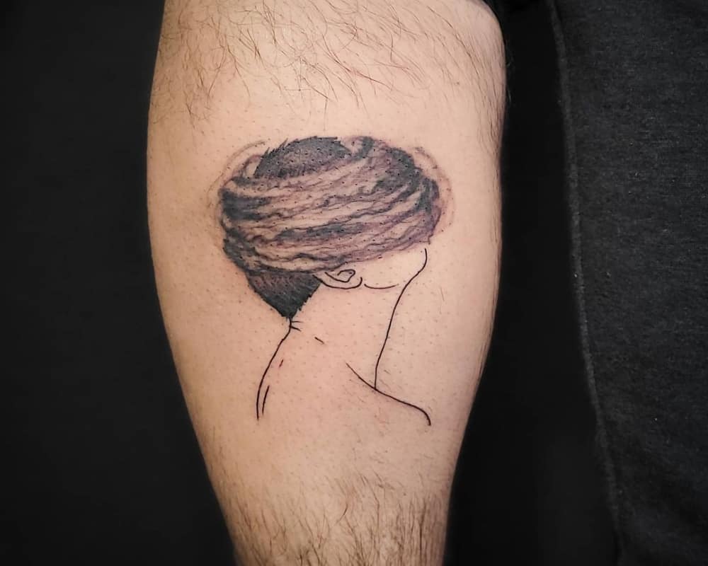 Tattoo of a head in a hurricane