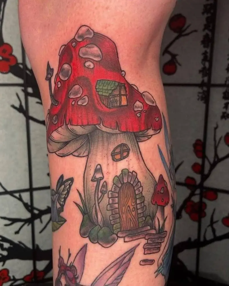 Tattoo of a house in the shape of a red mushroom