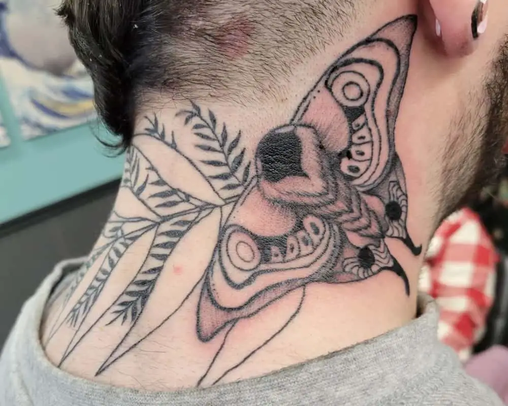 Tattoo of a large cicada on the neck