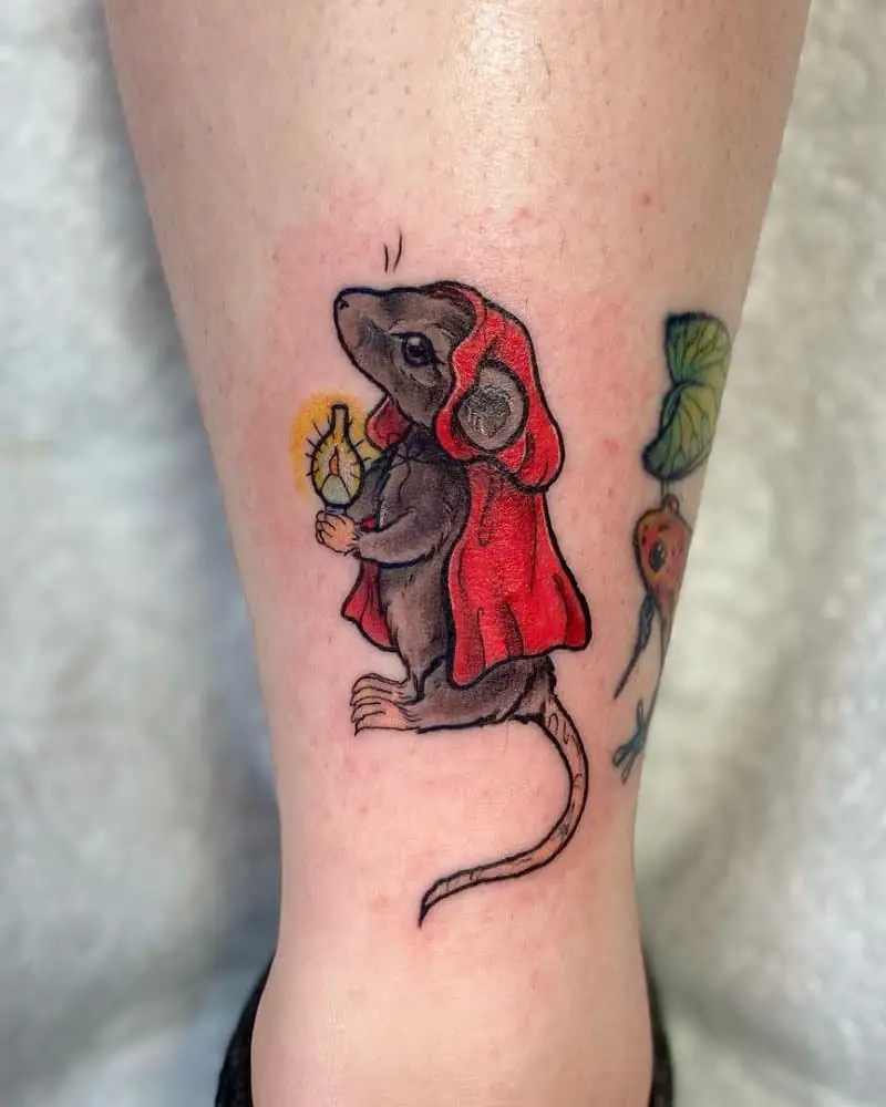 Tattoo of a mouse wearing a red cloak and a gas lamp in his paws