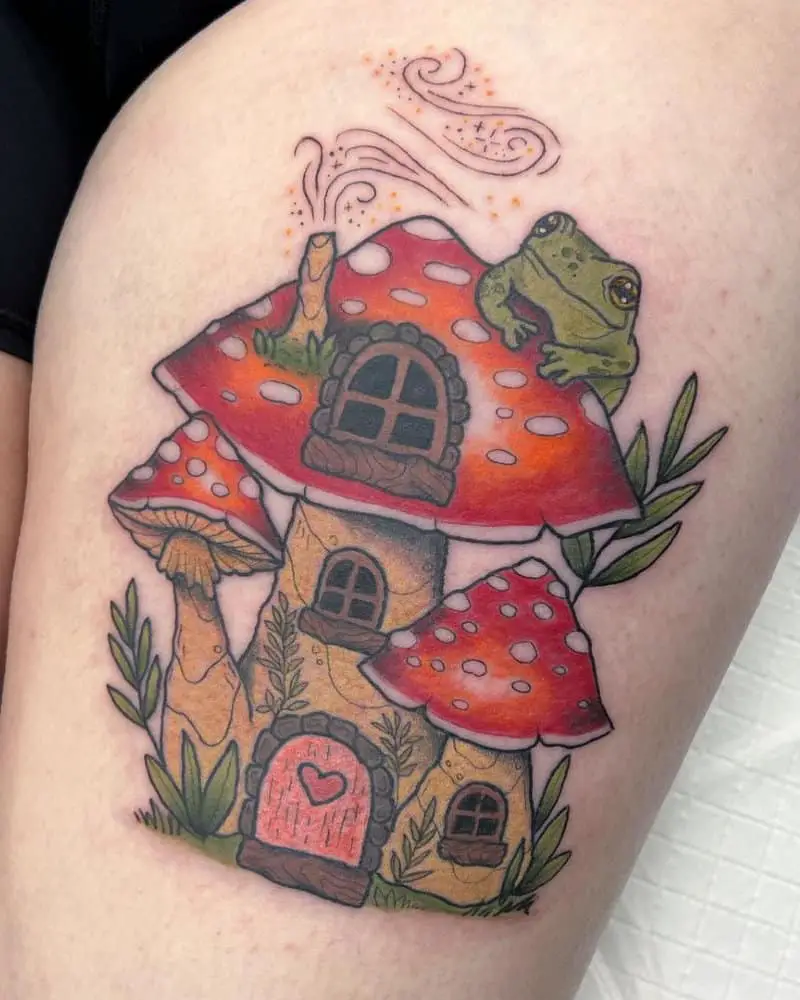 Tattoo of a mushroom-shaped house with a frog sitting on it