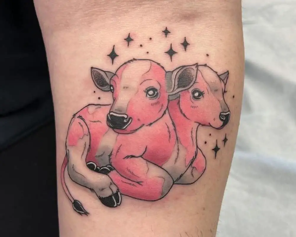 Tattoo of a pink lying two-headed calf under the stars