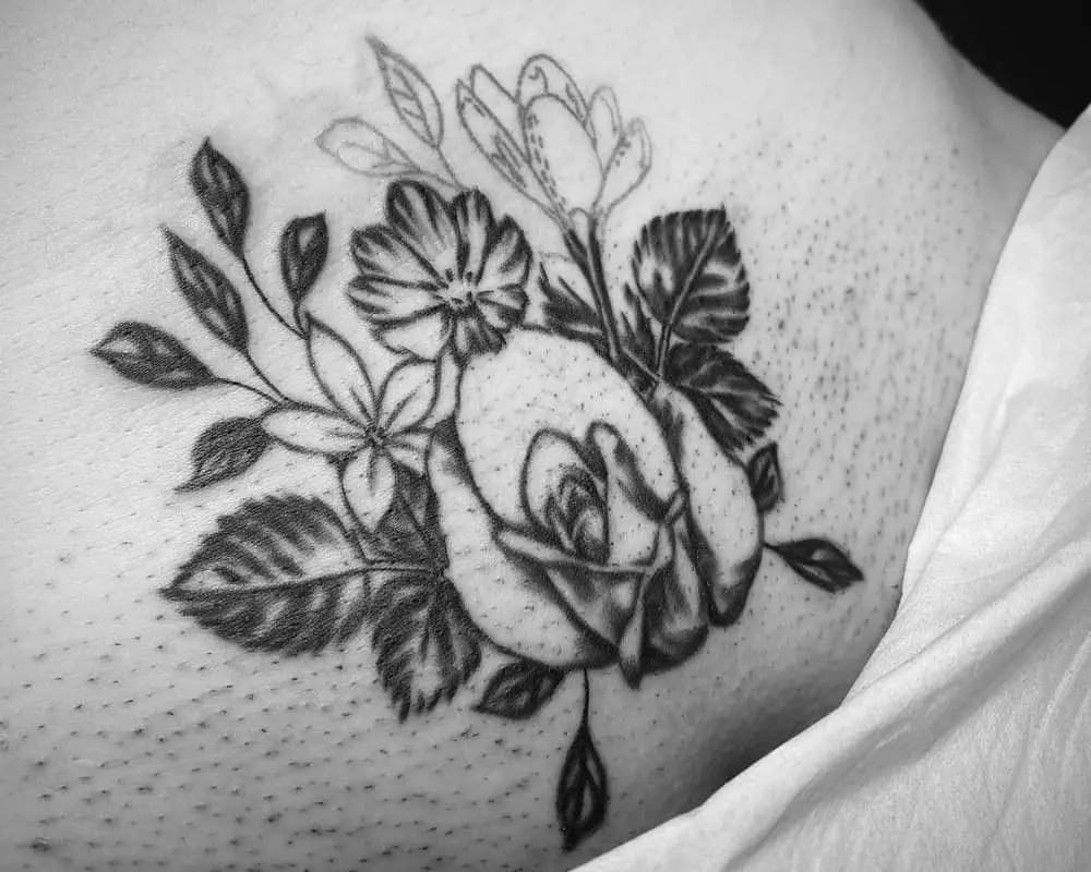 Tattoo of a rose and other flowers