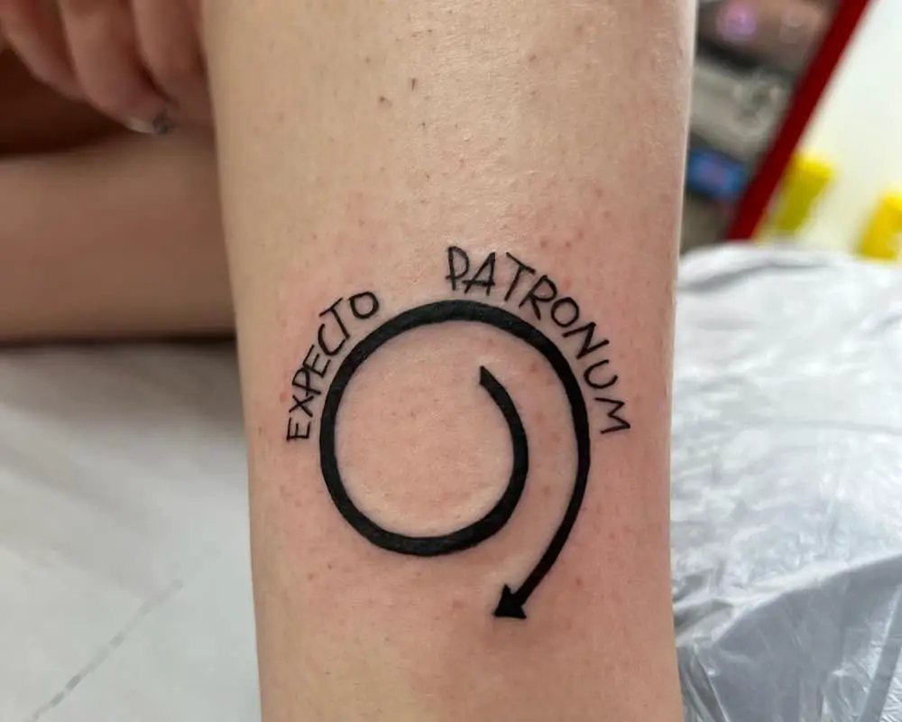 Tattoo of a spiral and Especto Patronum lettering