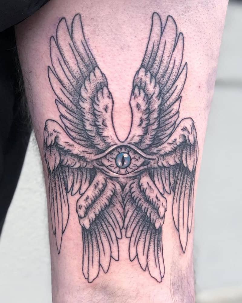 Tattoo of an angel with six wings and an eye in the center