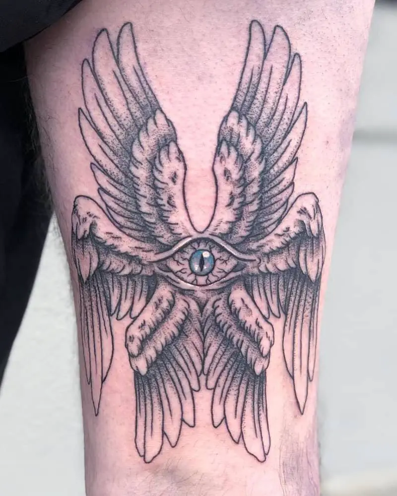 Tattoo of an angel with six wings and an eye in the center