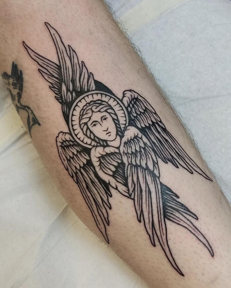 Tattoo of an angel with three pairs of wings and a face from an icon
