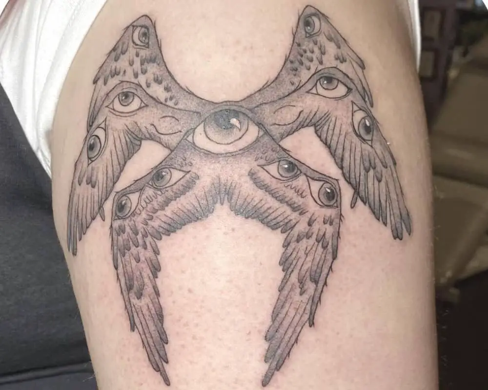 Tattoo of an angel with three pairs of wings with eyes