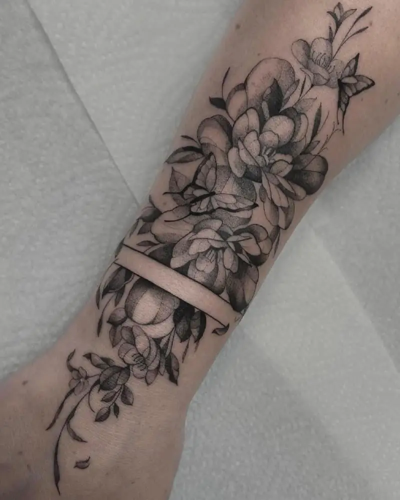 Tattoo of flowers and butterflies on the arm