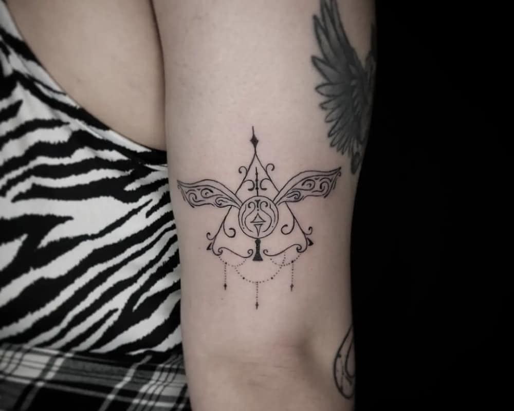 Tattoo of the Deathly Hallows and a golden snitch