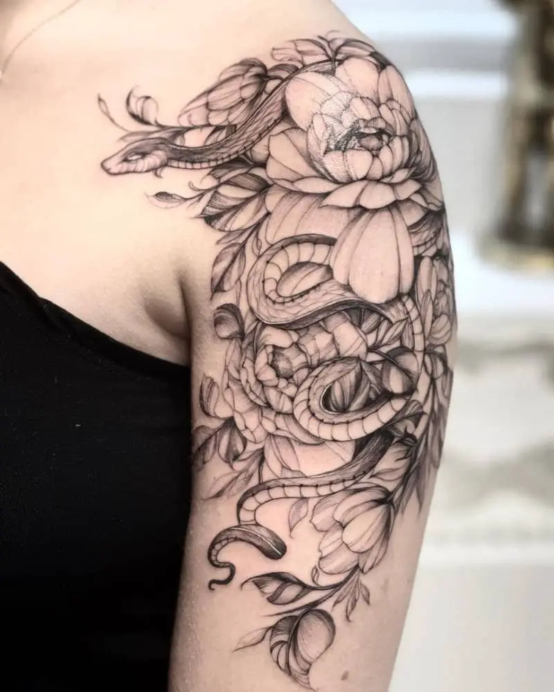 Tattoo on the shoulder with flowers and a snake