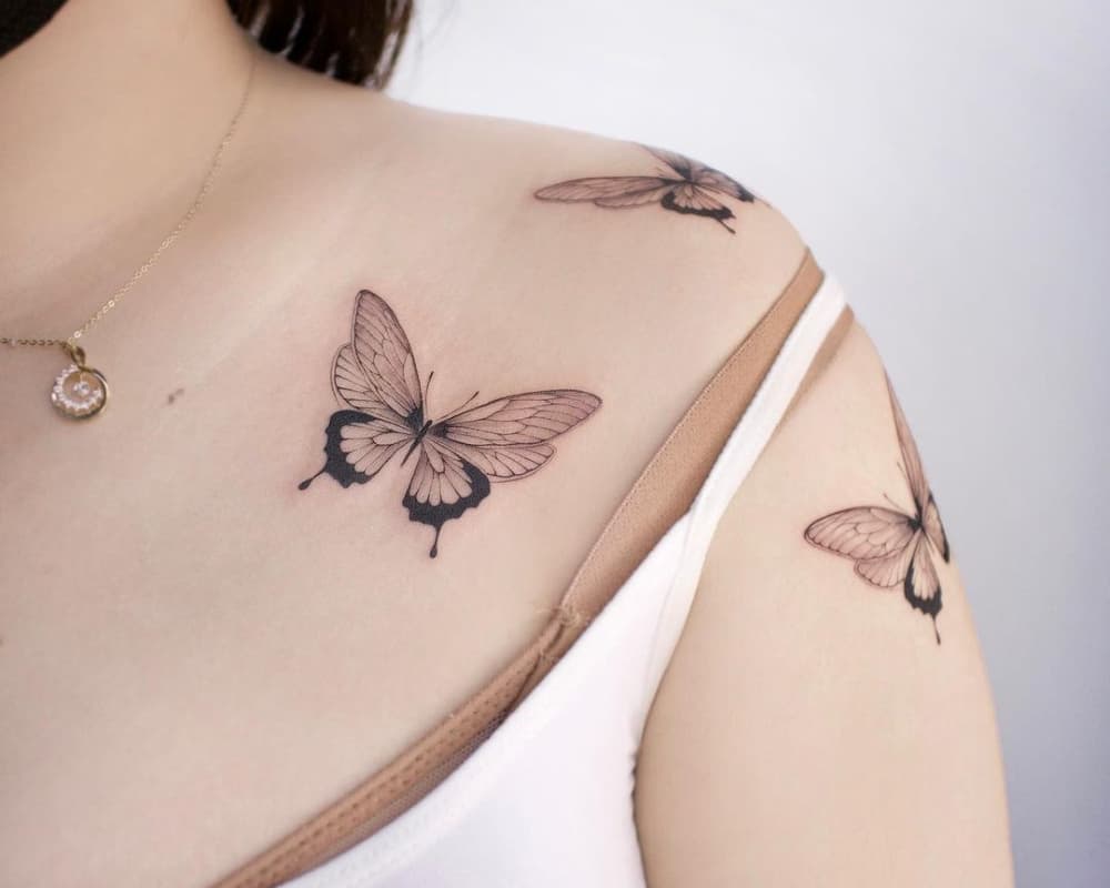 Three butterflies tattooed on the shoulder