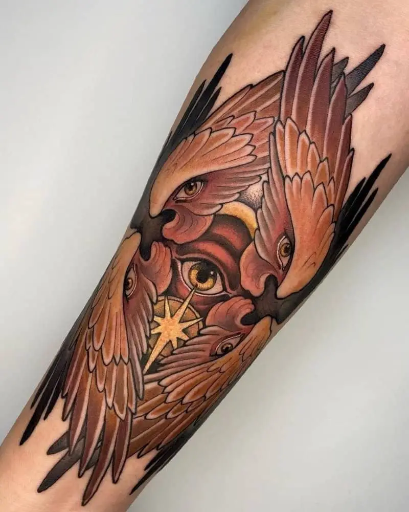 a beautiful tattoo depicting two pairs of wings with eyes and one eye in the centre with an eight-pointed star