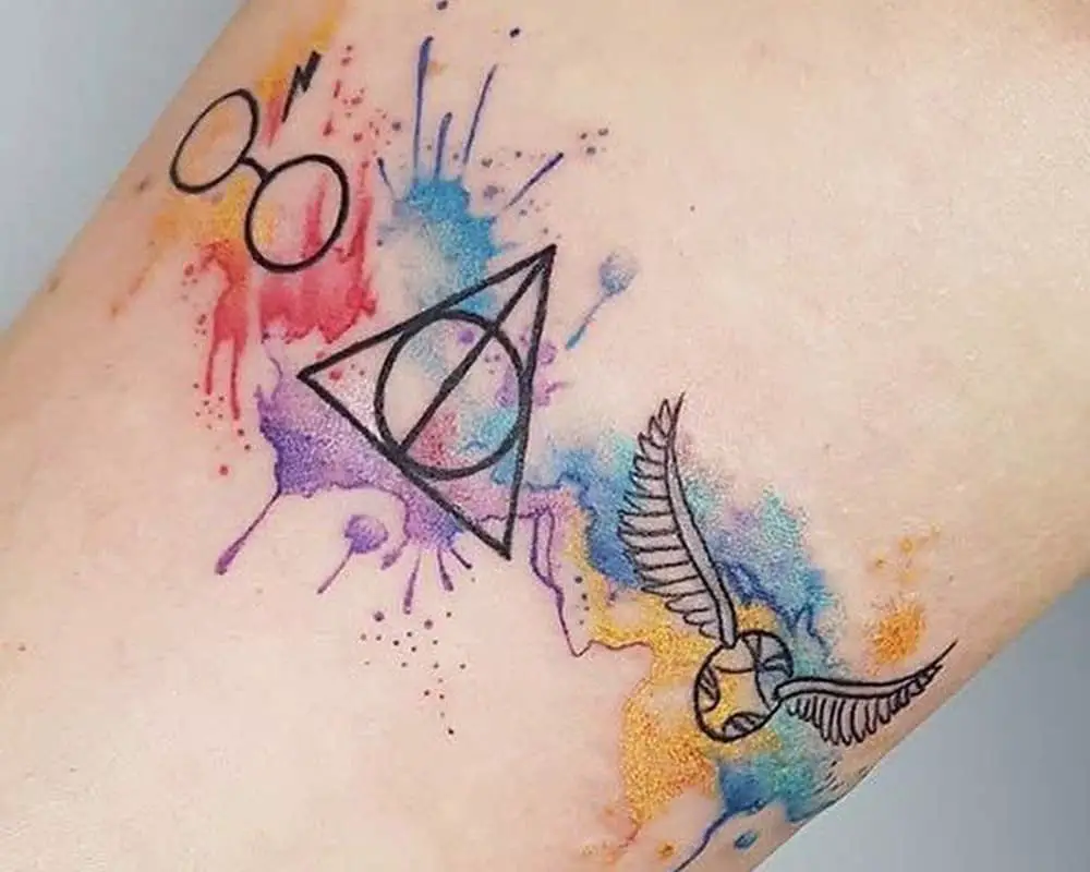 a bright tattoo of a scar and glasses, the sign of the Deathly Hallows, and a golden snitch