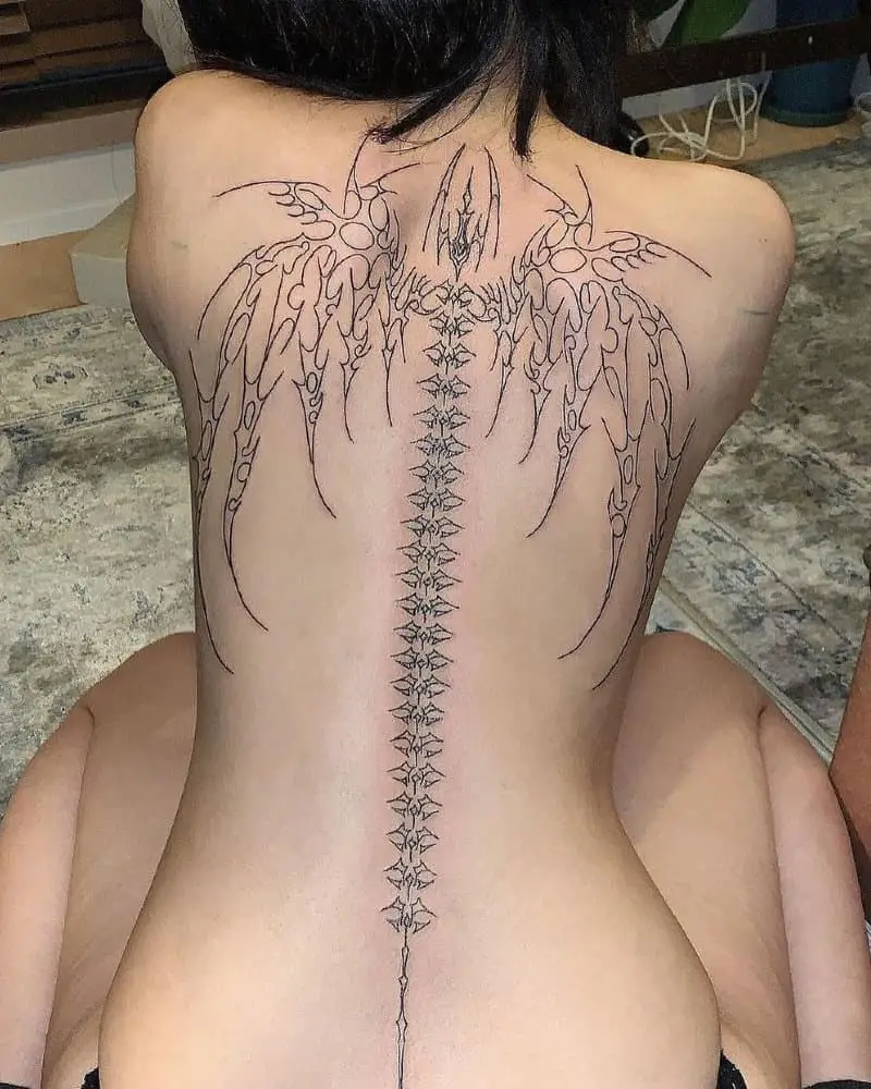 a full-back tattoo of a bone spine and wings