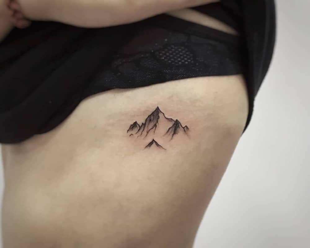a small tattoo in the form of mountains
