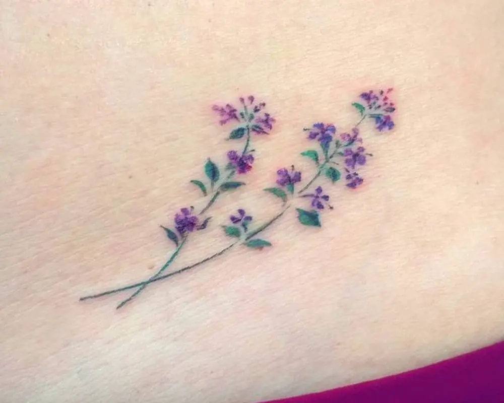 a small tattoo of lilac flowers