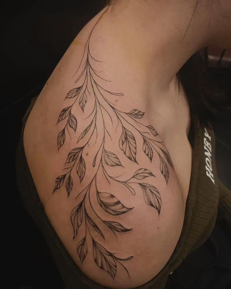 a tattoo in the form of a branch of a plant from neck to shoulder