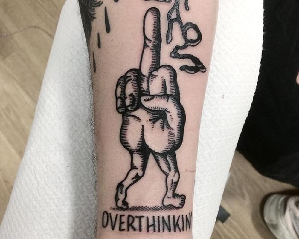 a tattoo in the form of a gesture of fuck with legs and the inscription overthinking