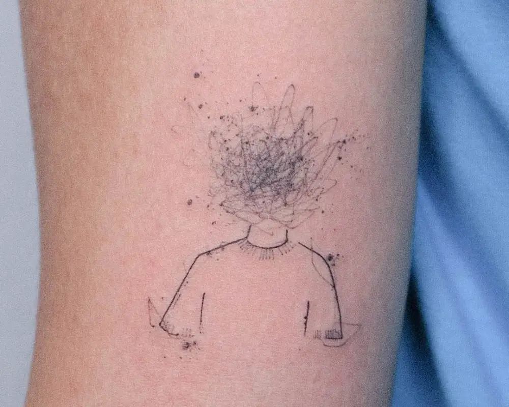 a tattoo in the form of a silhouette with a tangle instead of a head