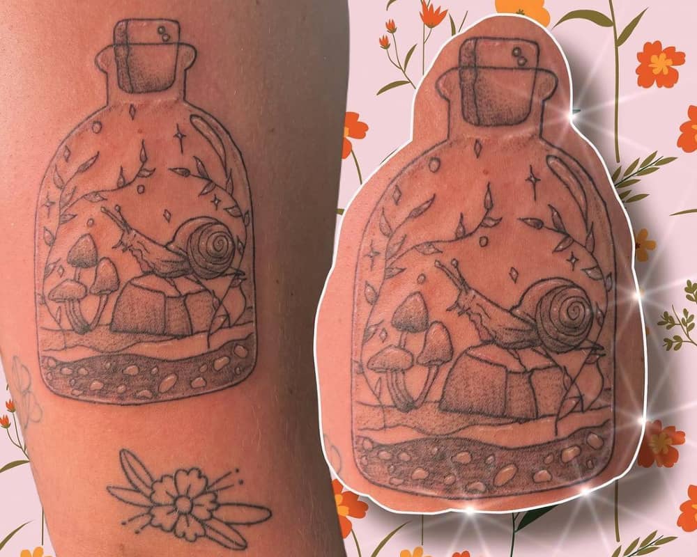 a tattoo in the shape of a jar containing a snail