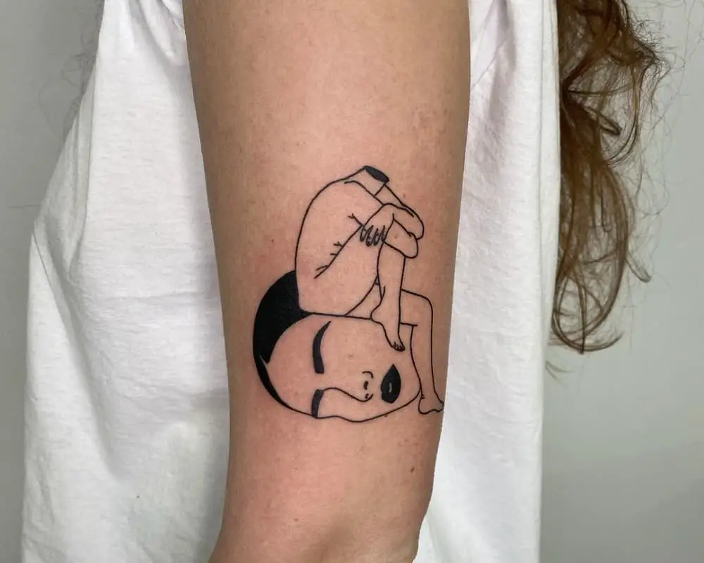 a tattoo of a body that sits on a big head