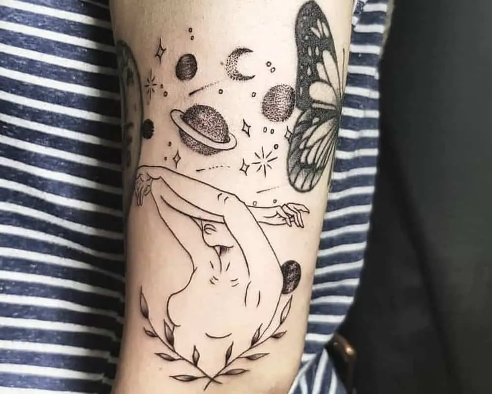 a tattoo of a girl who covers her face with her hands and space