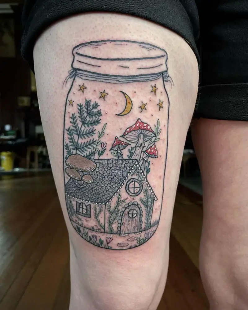 a tattoo of a jar with a mushroom house in it