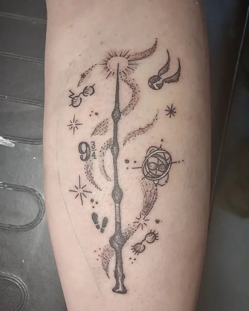 a tattoo of a magic wand around which are glasses, a snitch, footprints