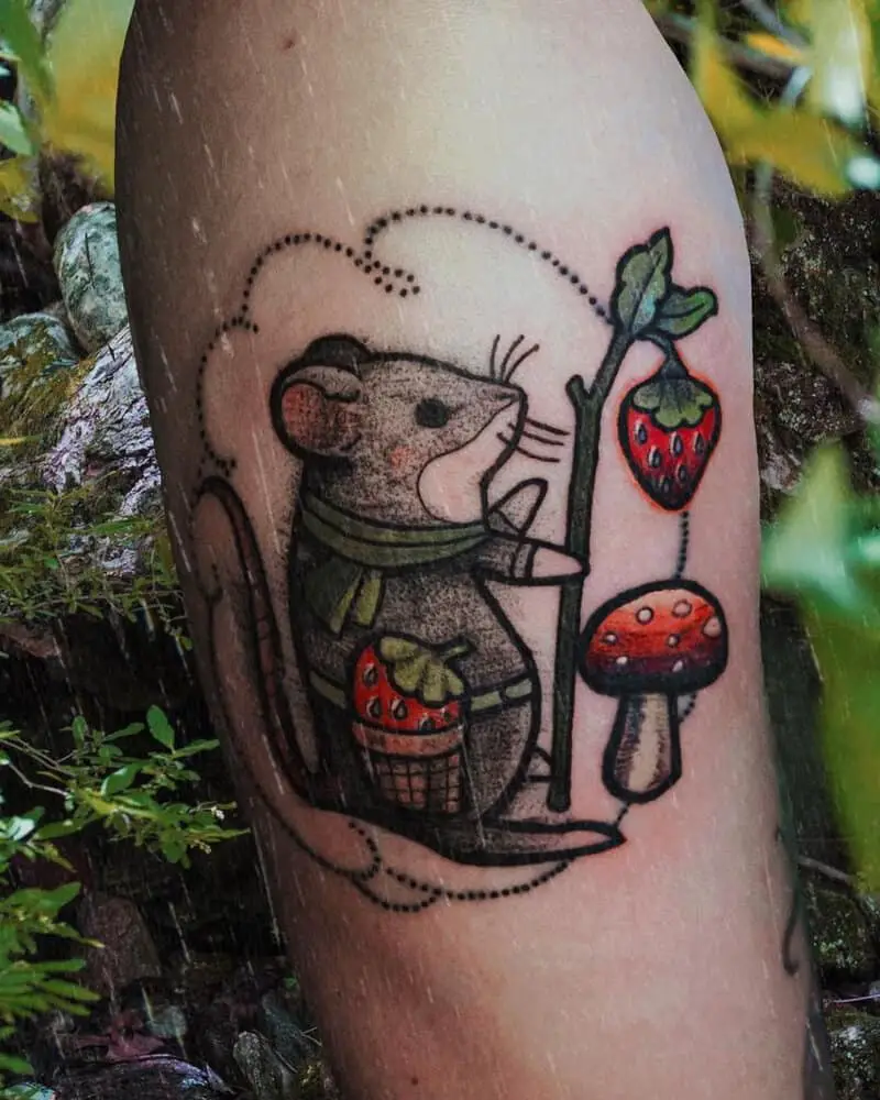 a tattoo of a mouse with a strawberry and a mushroom