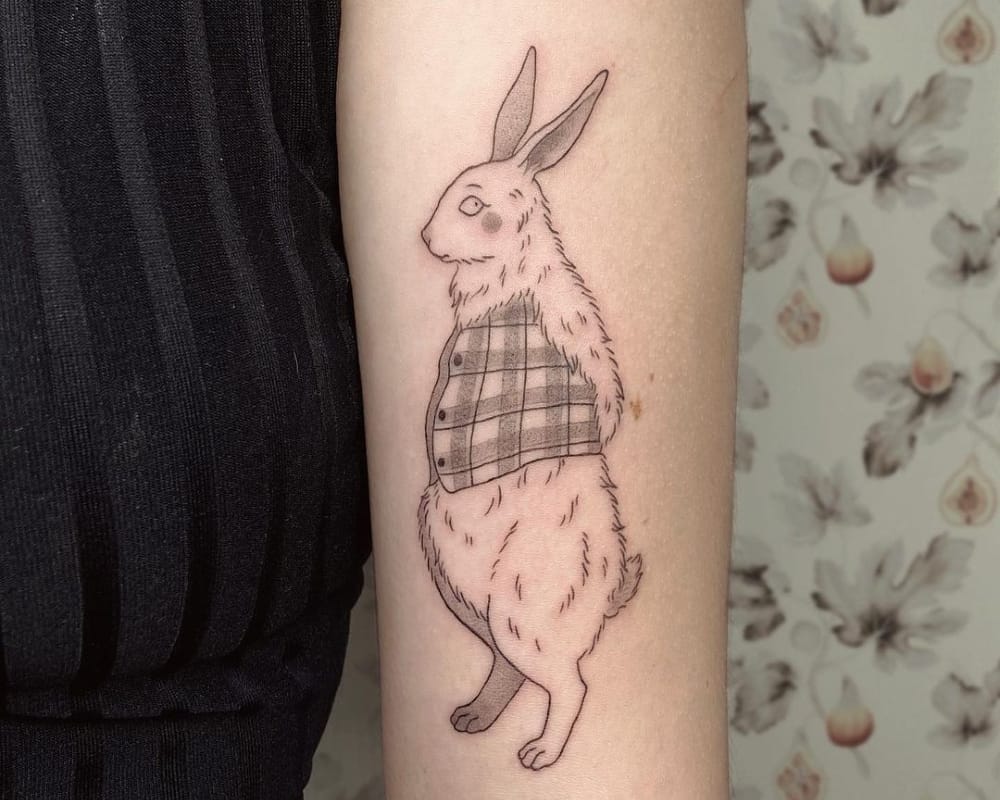 a tattoo of a rabbit in a plaid waistcoat