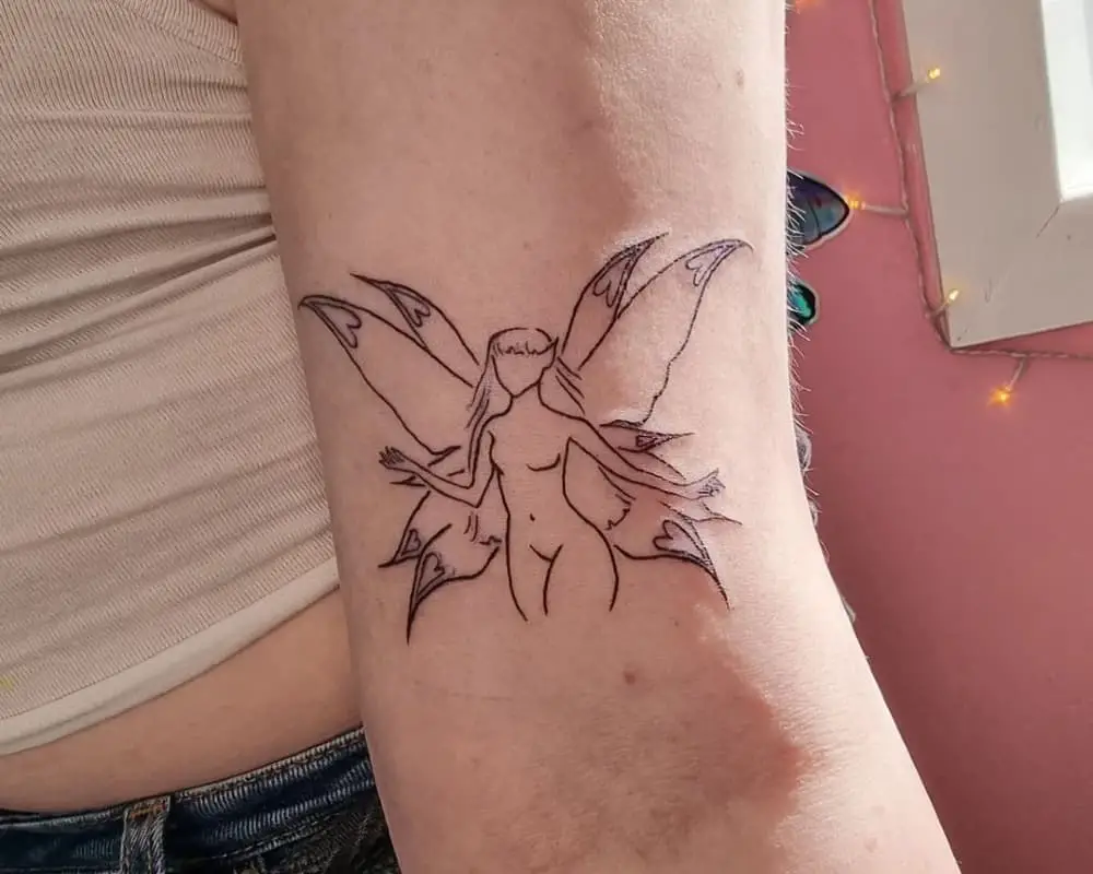 a tattoo of a sophisticated fairy silhouette