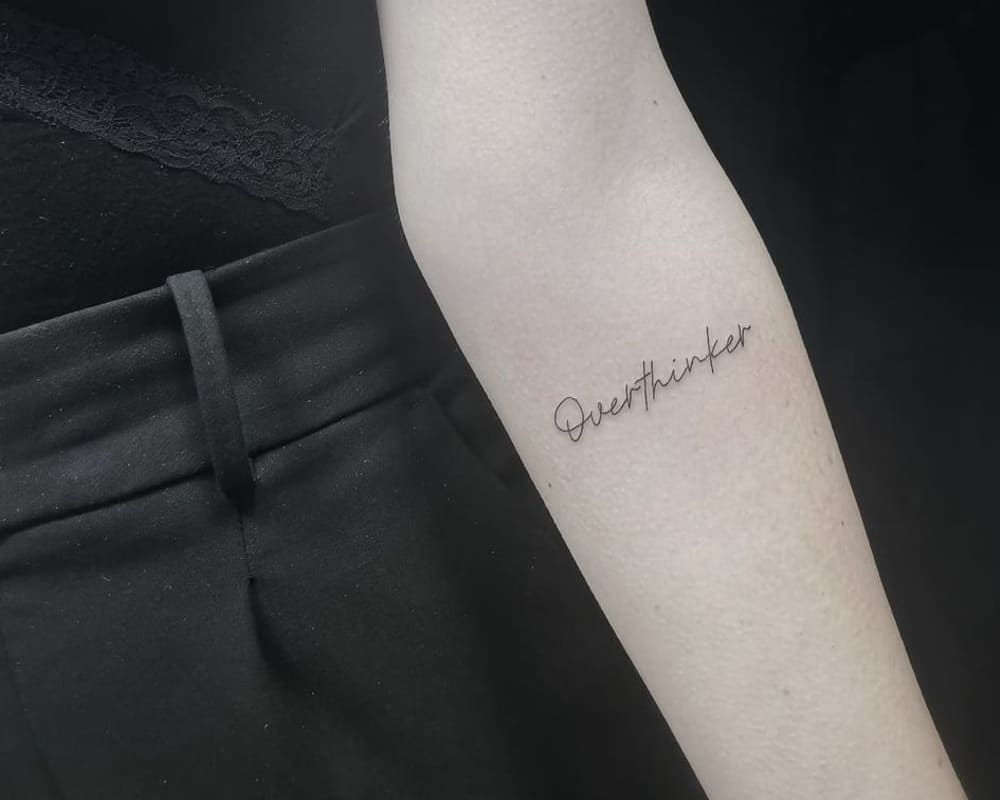 a tattoo of a thin overthinker inscription