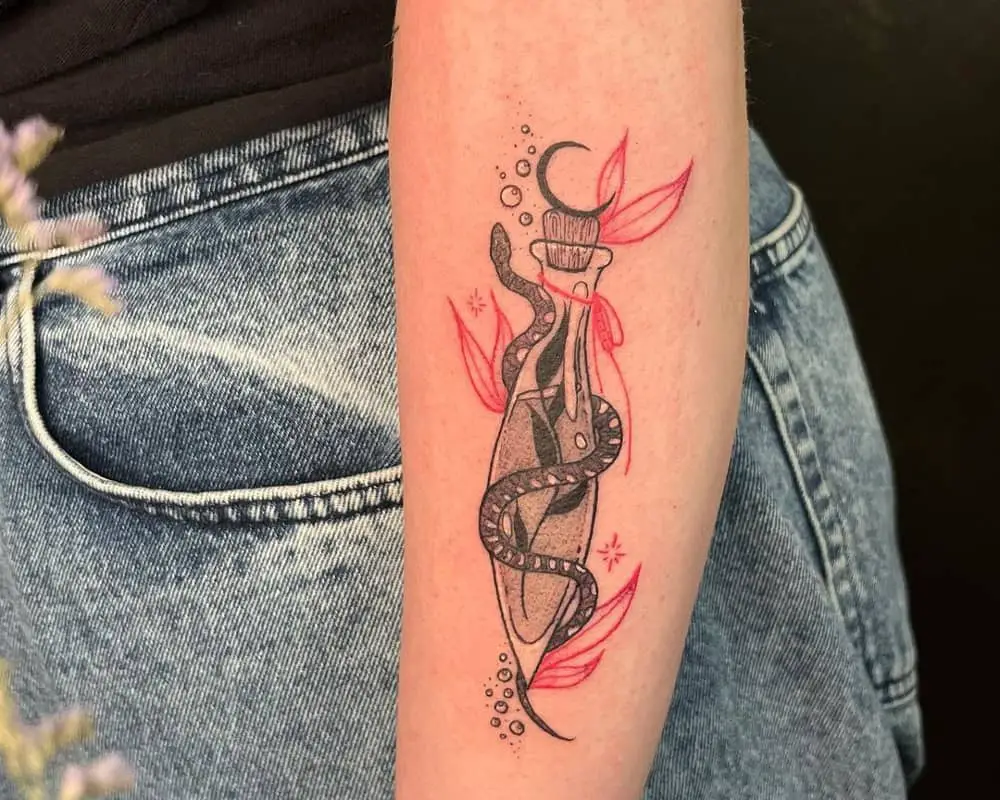 a tattoo of a vessel that is wrapped around a small snake