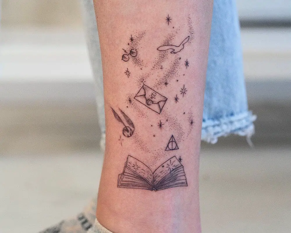 a tattoo of an open book with a snitch, a letter, an owl and glasses