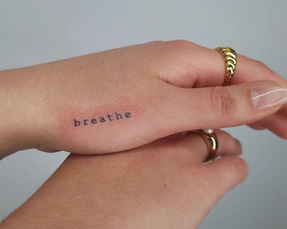 a tattoo of the word breathe