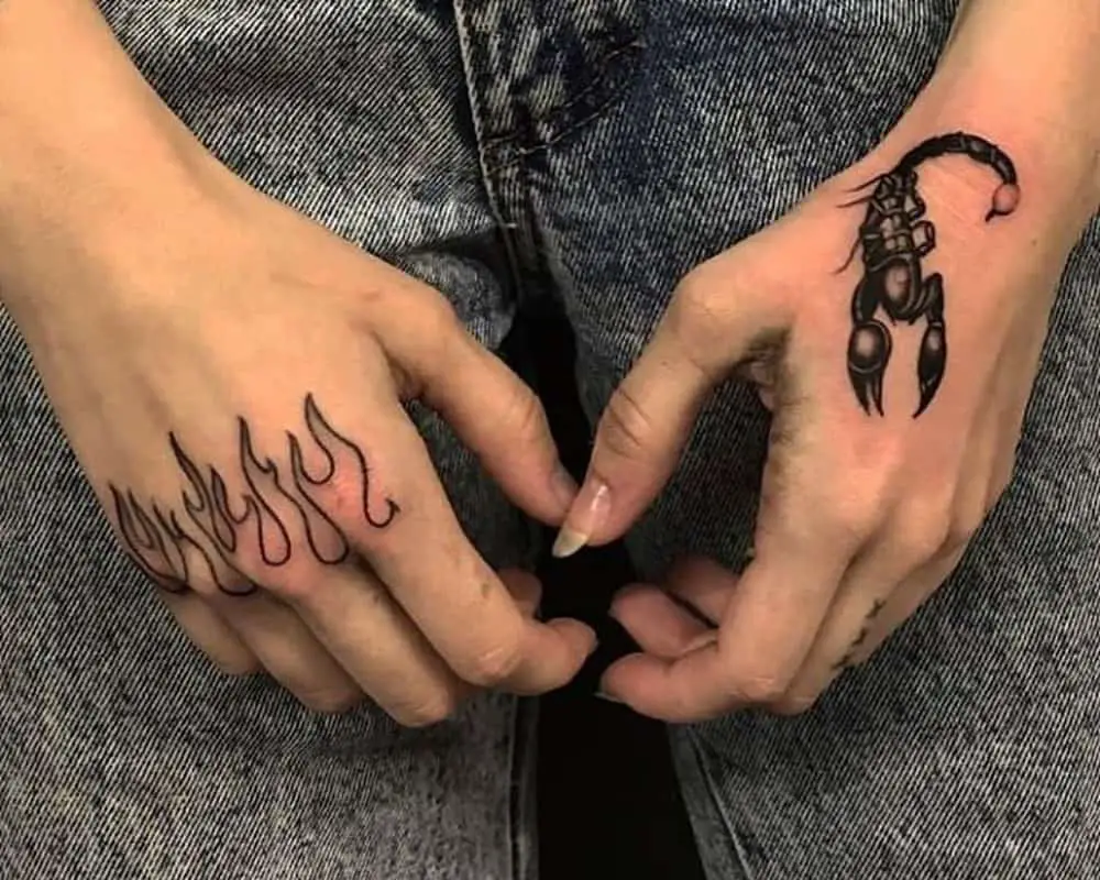 a tattoo with a scorpion on one arm and fire on the other