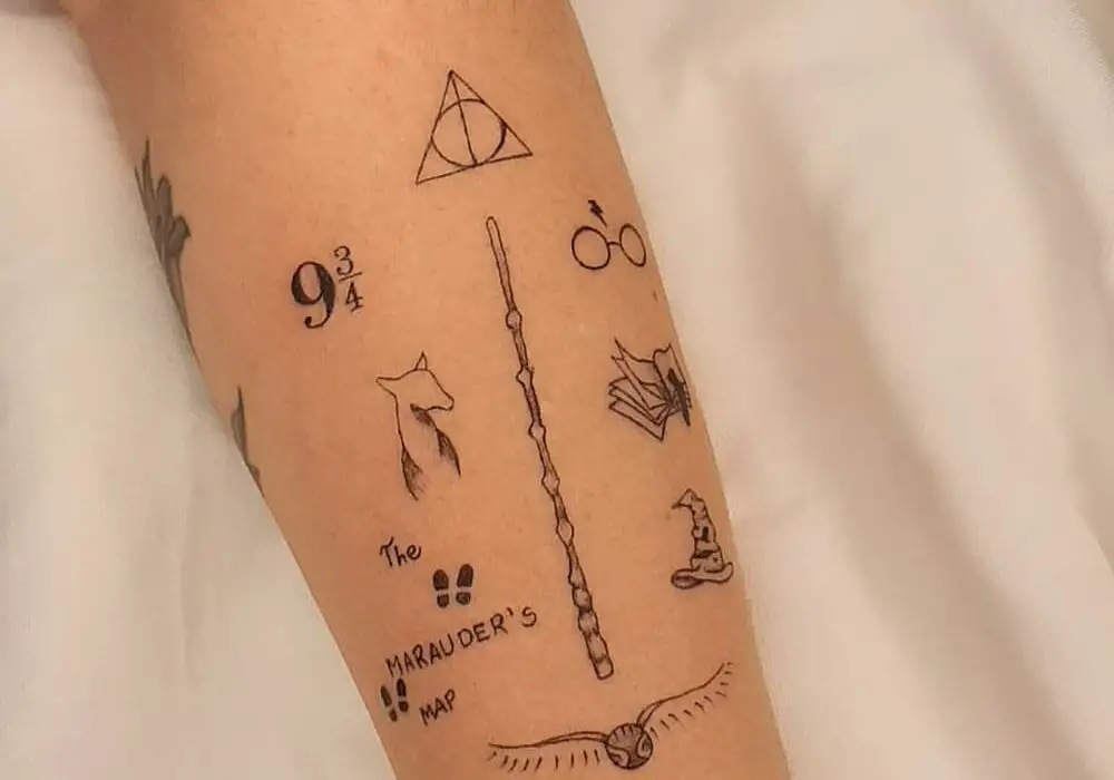 a very miniature tattoo of a scar and glasses, a sign of the Deathly Hallows, a golden snitch, a magic wand, a hat