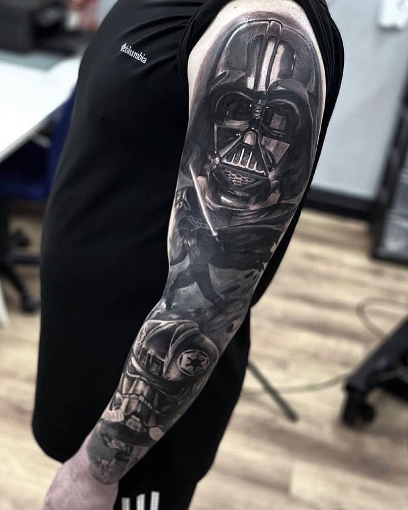 black and white full sleeve tattoo with Darth Vader and the Imperial Pilot