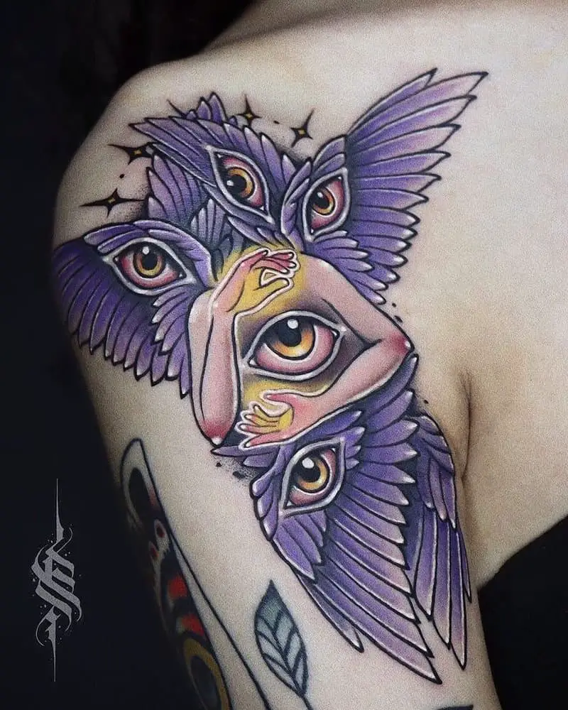 colored tattoo of an angel with six wings with eyes and two arms around the eye in the center