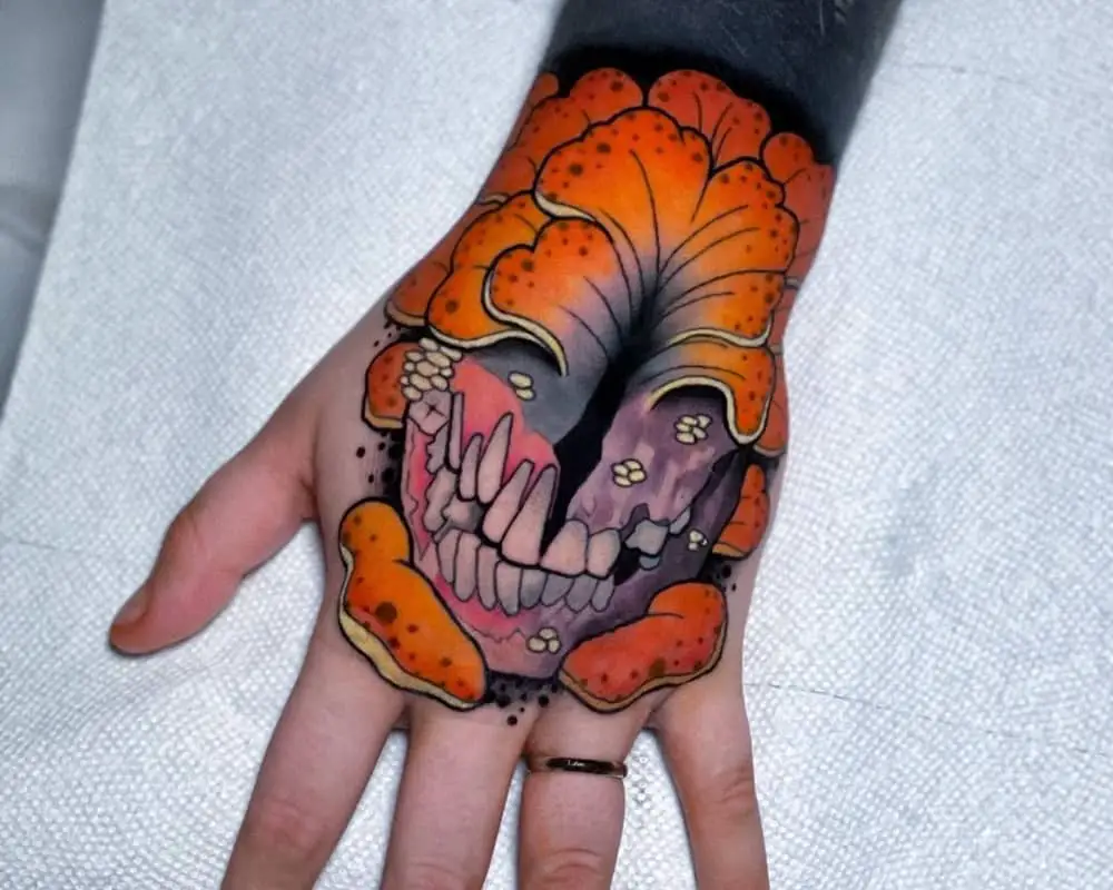 colored tattoo on the hand in the form of Clicker