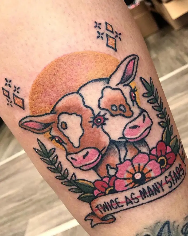 coloured tattoo in the shape of a two-headed calf with flowers and the inscription twice as many stars