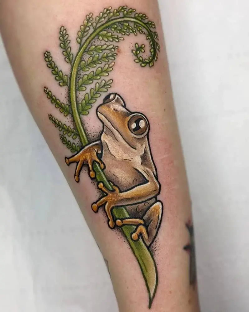 coloured tattoo of a frog on a plant sprig