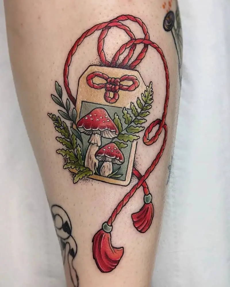 coloured tattoo of a mascot with mushrooms on it