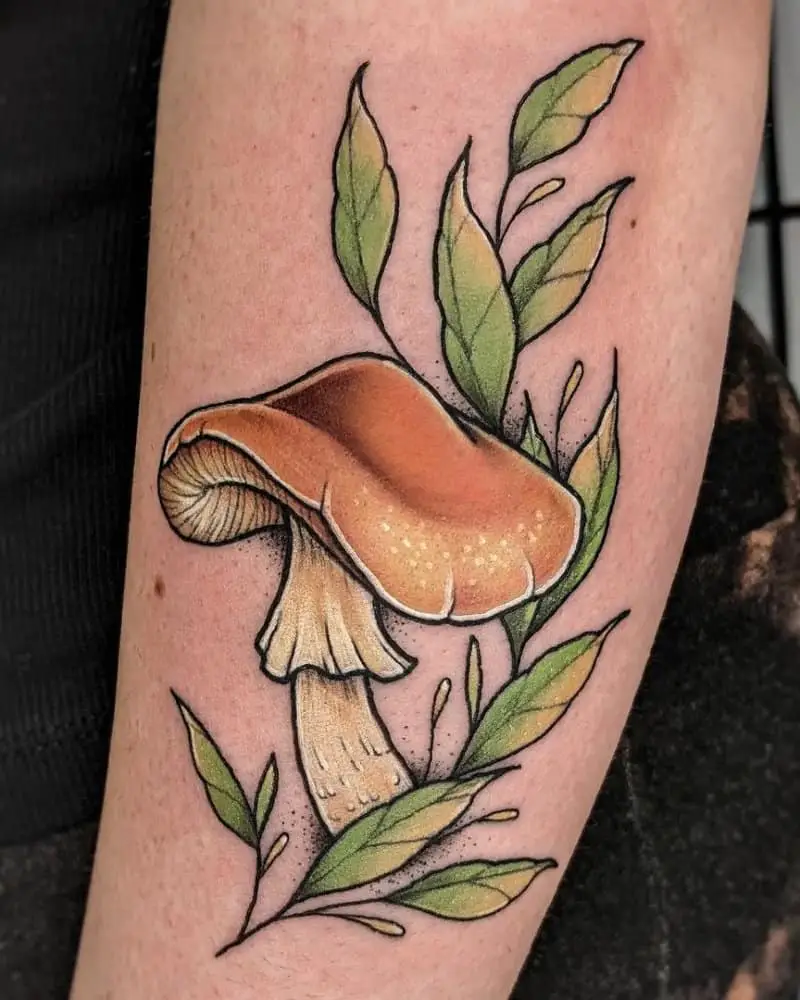 coloured tattoo with beige mushroom and green leaves