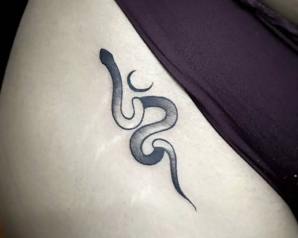 little tattoo of a snake with the moon