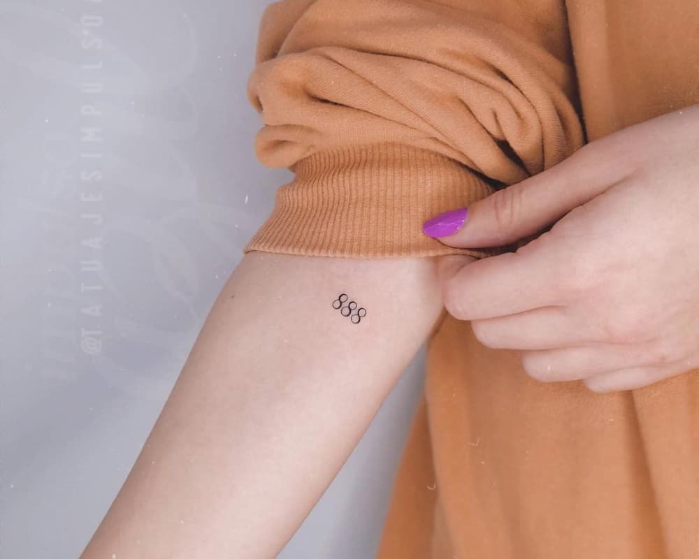 small 888 tattoo on the arm