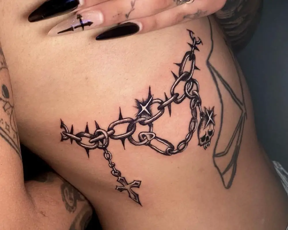 spiked chain and cross tattoo